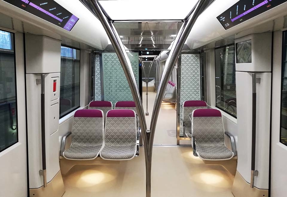 The interior of a Riyadh Metro carriage: the triangle pattern on the chairs is taken from the mud houses of Riyadh, while the vertical handrails resemble branching palm trees. The interior of a Riyadh Metro carriage: the triangle pattern on the chairs is taken from the mud houses of Riyadh, while the vertical handrails resemble branching palm trees.