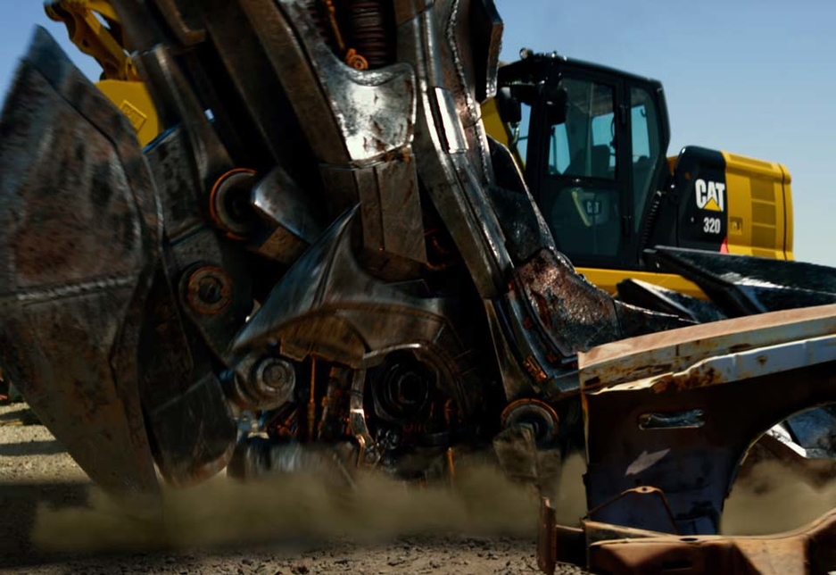 A couple of milliseconds later the Caterpillar excavator is largely obscured by the foot of the all-consuming antagonist of the film. A couple of milliseconds later the Caterpillar excavator is largely obscured by the foot of the all-consuming antagonist of the film.