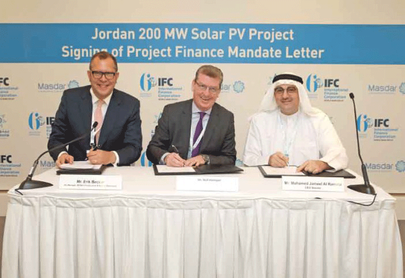 Eric Becker of IFC signs the agreement with Niall Hannigan and Mohamed Jameel Al Ramahi of Masdar (Pic courtesy: WAM). Eric Becker of IFC signs the agreement with Niall Hannigan and Mohamed Jameel Al Ramahi of Masdar (Pic courtesy: WAM).
