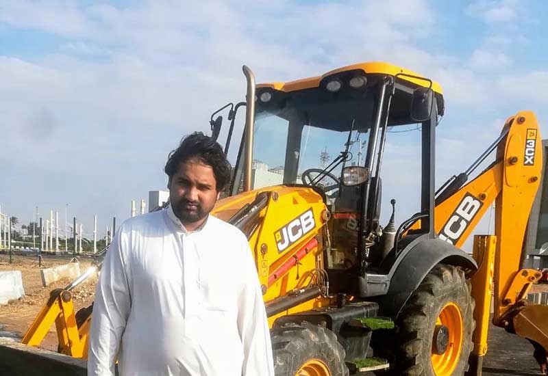 Omer Mukhtar with the recovered JCB 3CX backhoe loader. Omer Mukhtar with the recovered JCB 3CX backhoe loader.