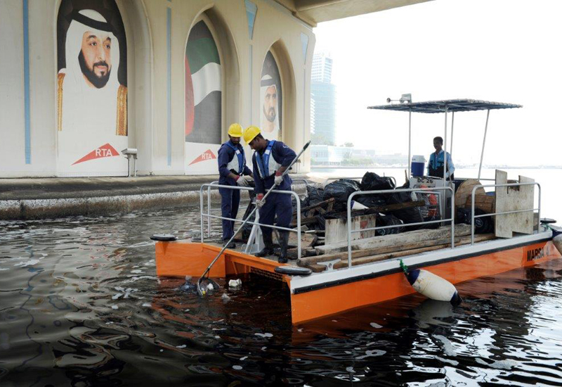 A waterway clean-up boat in operation. A waterway clean-up boat in operation.