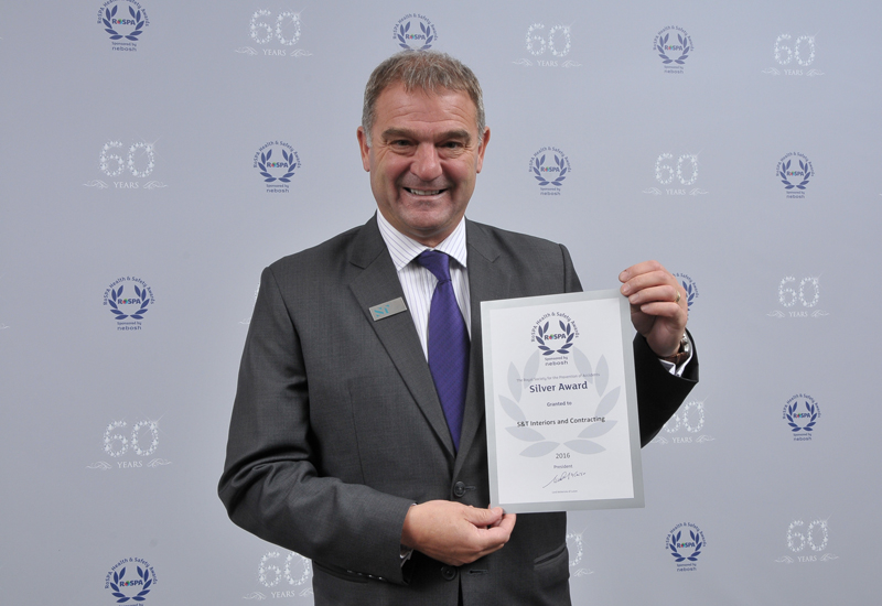 Wayne Taylor (above), group head of HSE at S&T Interiors and Contracting, collected the firm’s silver award at the 60th RoSPA Occupational Health and Safety Awards. Wayne Taylor (above), group head of HSE at S&T Interiors and Contracting, collected the firm’s silver award at the 60th RoSPA Occupational Health and Safety Awards.