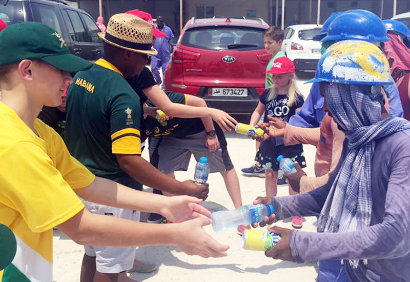 A handful of South Africans hand out water and cool drinks to workers coming off shift on one of Doha's construction sites. A handful of South Africans hand out water and cool drinks to workers coming off shift on one of Doha's construction sites.