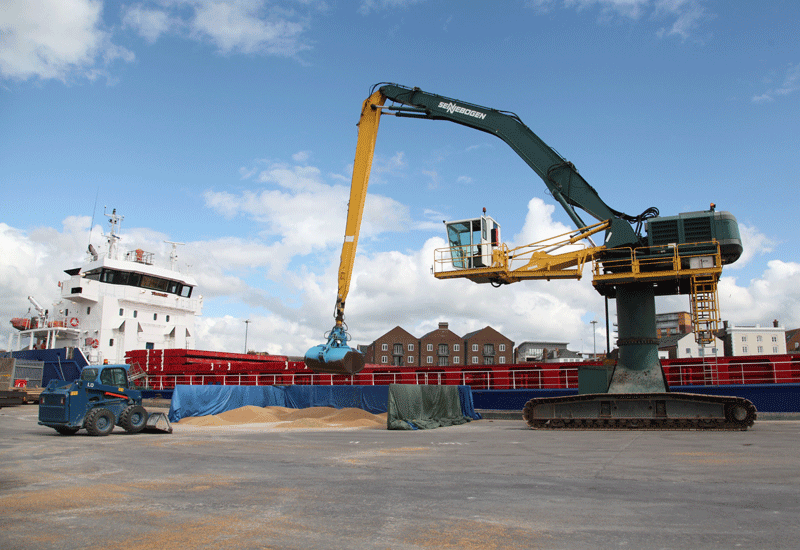 Little and large: PHC’s Bobcat S630 (left) works in tandem with the port’s Sennebogen grab crane (right). Little and large: PHC’s Bobcat S630 (left) works in tandem with the port’s Sennebogen grab crane (right).