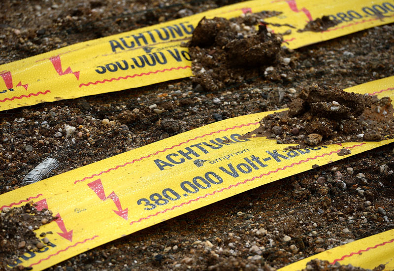 Hazard tape warns of high-voltage cables lurking in the substrate. Hazard tape warns of high-voltage cables lurking in the substrate.