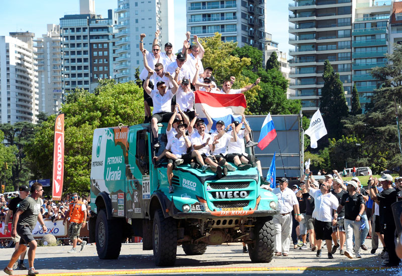 De Rooy's team celebrate and wave Italian flags fromon top of their triumphant Iveco Powerstar. De Rooy's team celebrate and wave Italian flags fromon top of their triumphant Iveco Powerstar.