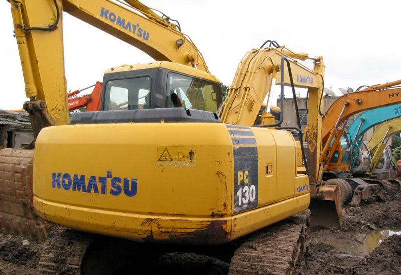 A Komatsu sulks in a used machinery lot. A Komatsu sulks in a used machinery lot.