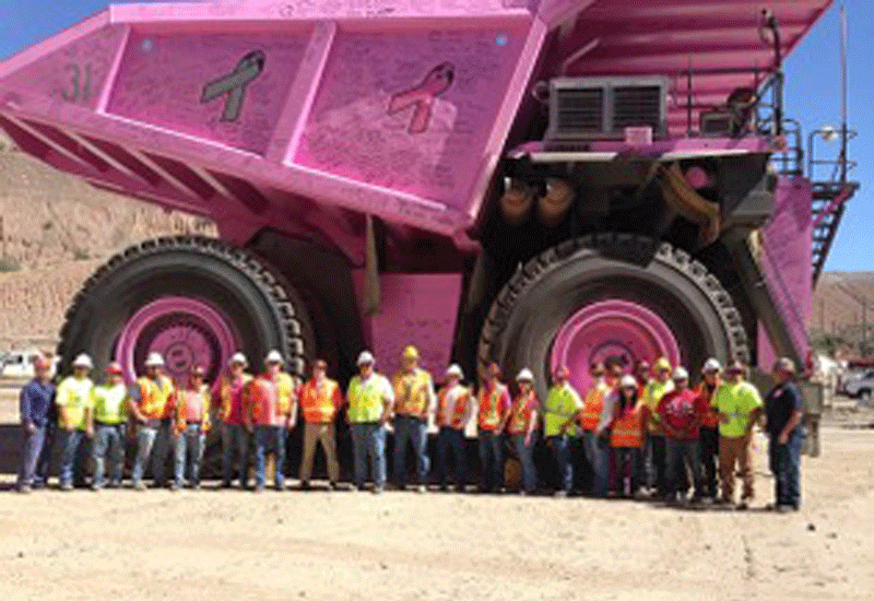 Employees of ASARCO Ray Mine posing in front of their big, pink Liebherr hauler. Employees of ASARCO Ray Mine posing in front of their big, pink Liebherr hauler.