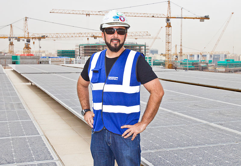 Manos Kappas stands amid the solar array on the DI Annex building Msheireb. A total of 1,550 solar panels stretch over the roof, producing 340kW peak Manos Kappas stands amid the solar array on the DI Annex building Msheireb. A total of 1,550 solar panels stretch over the roof, producing 340kW peak