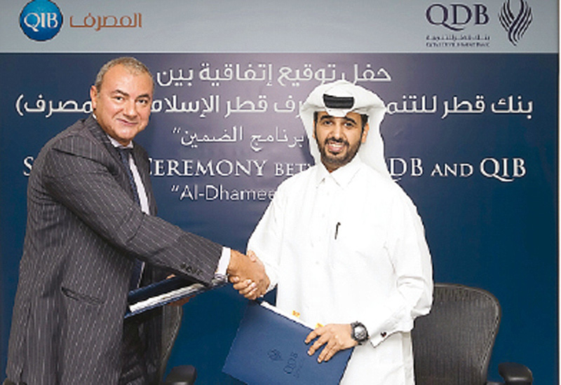 Qatar Development Bank (QDB) announced that Abdulaziz bin Nasser Al Khalifa, CEO of QDB, and Bassel Gamal, Qatar Islamic Bank (QIB) Group CEO, signed a new Al Dhameen Programme Portfolio Agreement. Qatar Development Bank (QDB) announced that Abdulaziz bin Nasser Al Khalifa, CEO of QDB, and Bassel Gamal, Qatar Islamic Bank (QIB) Group CEO, signed a new Al Dhameen Programme Portfolio Agreement.