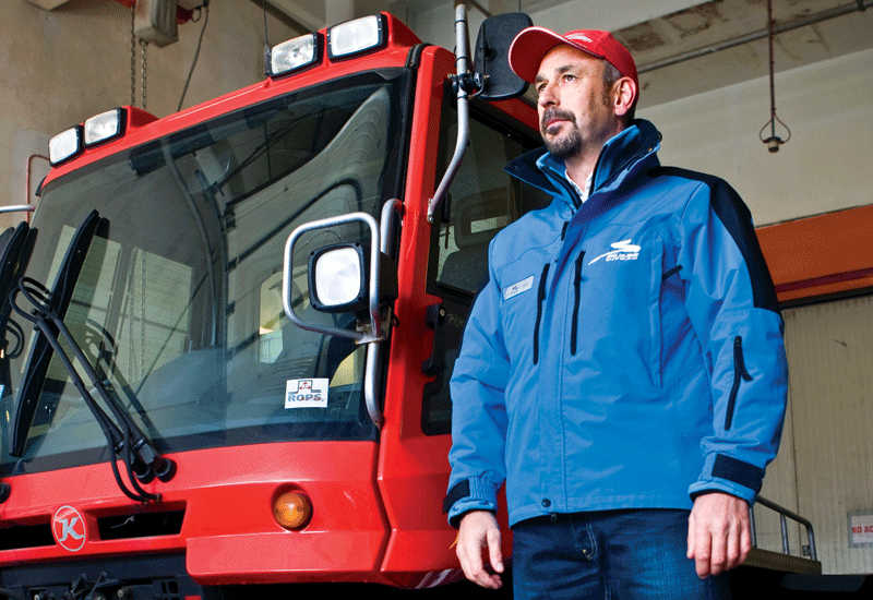 Paul Rivet stands next to the PistenBully snow grooming machine. Paul Rivet stands next to the PistenBully snow grooming machine.