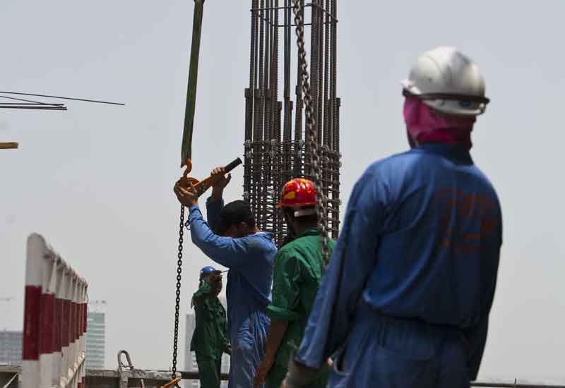 Workers on the roof of SinoGulf last year. Workers on the roof of SinoGulf last year.