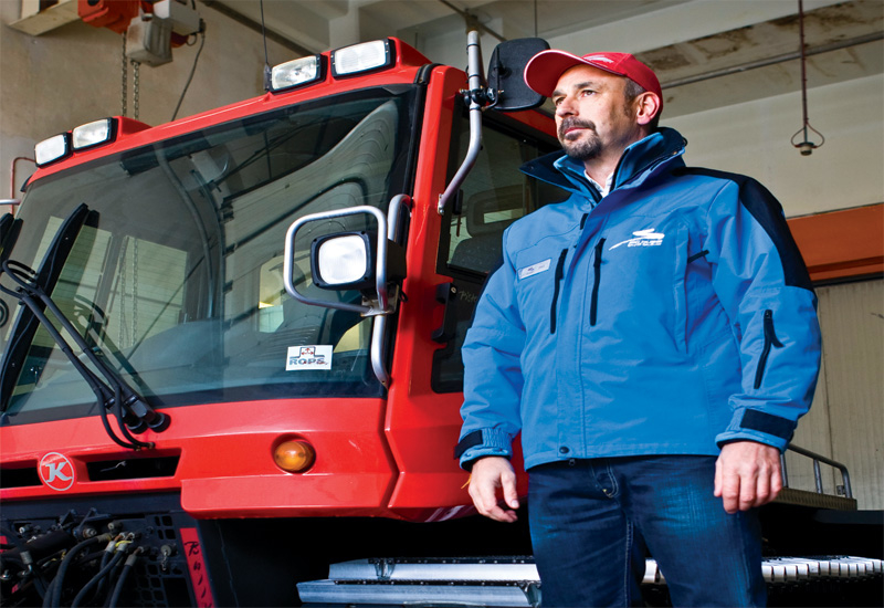 Paul Rivet stands next to the PistenBully snow grooming machine. Paul Rivet stands next to the PistenBully snow grooming machine.