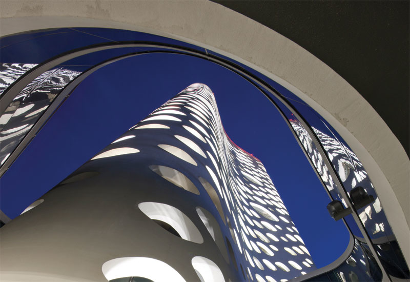 The 41cm-thick concrete facade of the O14 tower is perforated by 1,000 circular openings. The 41cm-thick concrete facade of the O14 tower is perforated by 1,000 circular openings.