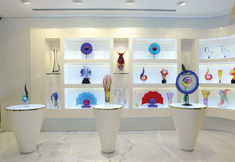 The glass art is displayed in a gallery-like space. The glass art is displayed in a gallery-like space.