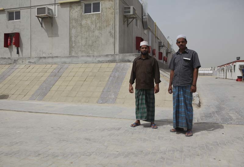 Two workers at the Nad Al Sheba camp. Two workers at the Nad Al Sheba camp.